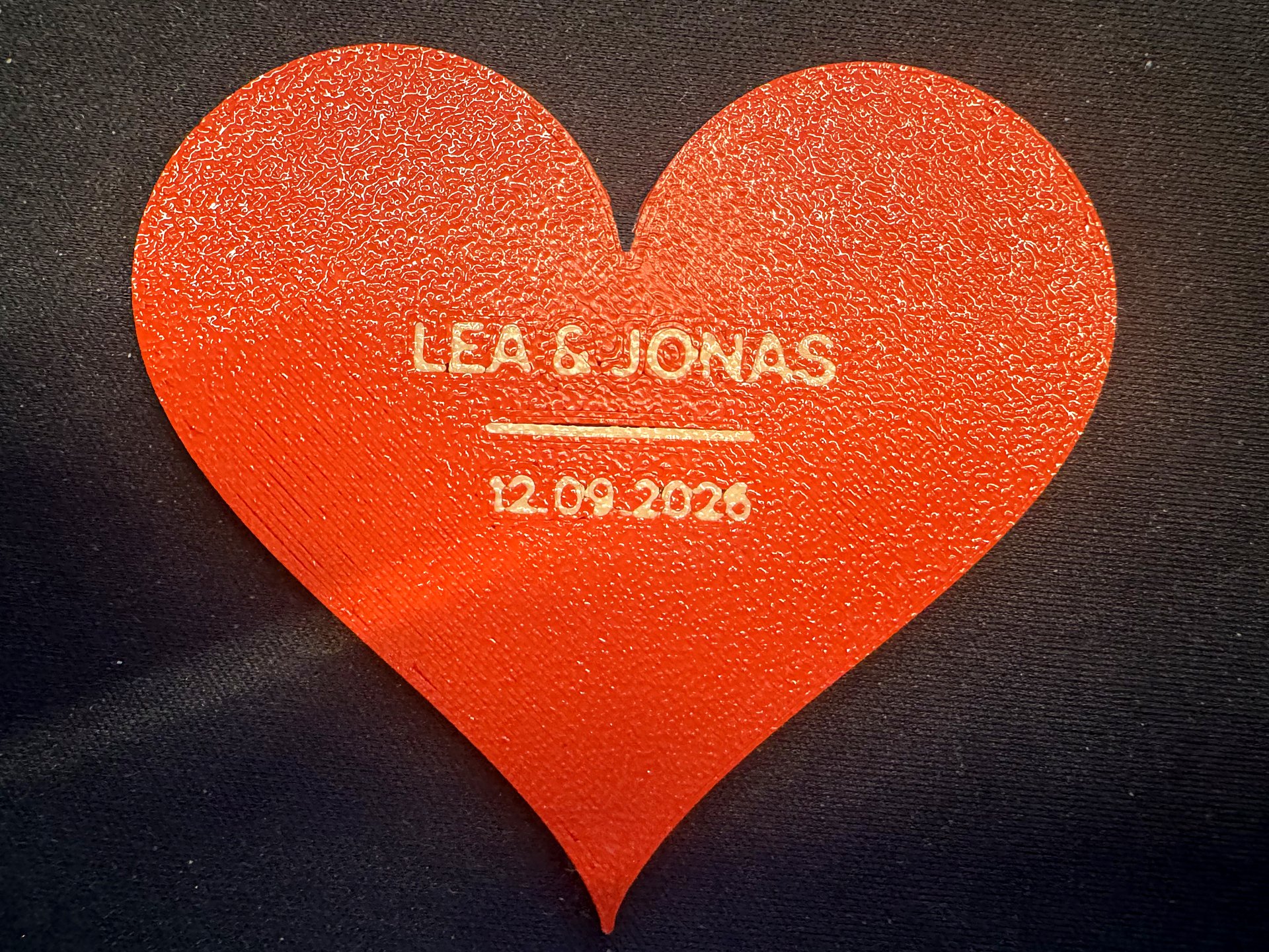 Rotes 3D-gedrucktes Herz mit den Namen Lea und Jonas und einem Hochzeitsdatum